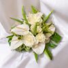 beautiful white anthurium and roses with an assortment of green ferns, ti and palm leaves